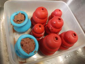 Stuffed Kong and Toppl dog toys, ready for the Freezer